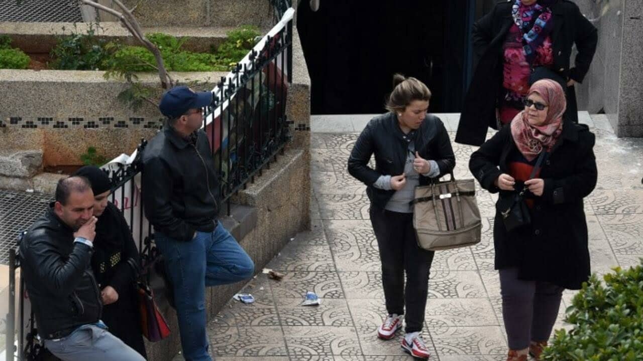 TO GO WITH AFP STORY BY SARAH MOULAI
Women walk past a metro station in Algiers on March 16, 2015. Harassment in public places in Algeria is now punished by two to six months of prison since a law criminalising violence against women was voted on earlier this month. AFP PHOTO / FAROUK BATICHE