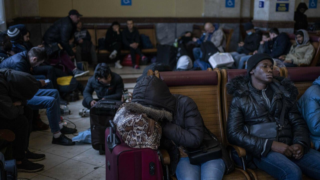FILE - Ukrainians and foreign residents wait for trains inside Lviv railway station, Feb. 28, 2022, in Lviv, west Ukraine. Jarred by discriminatory treatment and left to evacuate themselves from Ukraine, people from African, Asian and Latin American countries who succeed in getting out are forming impromptu networks to help thousands of others hoping to flee. (AP Photo/Bernat Armangue, File)