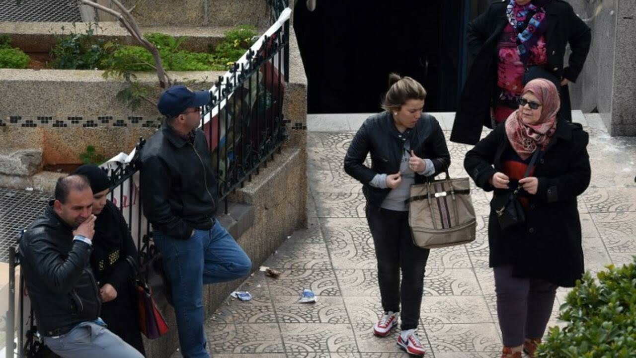 TO GO WITH AFP STORY BY SARAH MOULAI
Women walk past a metro station in Algiers on March 16, 2015. Harassment in public places in Algeria is now punished by two to six months of prison since a law criminalising violence against women was voted on earlier this month. AFP PHOTO / FAROUK BATICHE