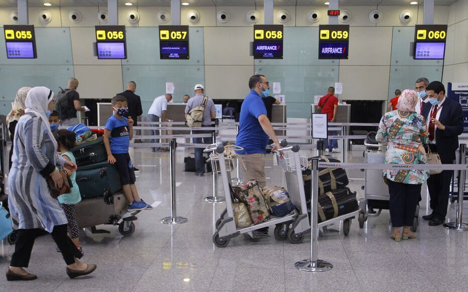 Passengers wait to check-in at an Air France counter for a flight to Paris at Algiers' Houari Boumediene Airport on June 1, 2021, after Algeria reopened its borders following a 15-months closure due to the Covid-19 pandemic. - Algeria has slightly relaxed the conditions for entry to its soil of its nationals stranded abroad due to the Covid-19 epidemic, by reducing the costs of compulsory confinement, a statement from the Council of Ministers said. (Photo by - / AFP)