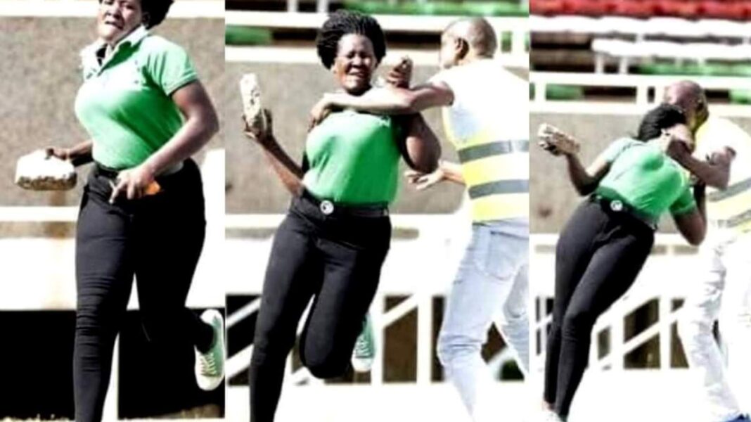 Scènes amusantes… La femme d’un joueur blessé lors de la ligue kenyane a pris d’assaut le stade à coups de pierres Femme en vert lançant une pierre lors d'une altercation au stade.