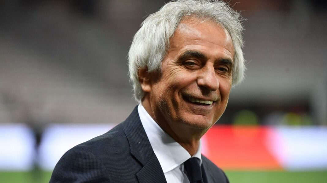 Vieux coach de football souriant Homme d'âge moyen en costume souriant lors d'un match de football.