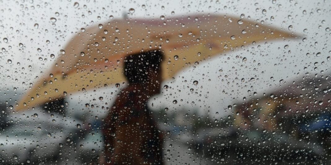 Pluie sur une voiture en Algérie Personne avec parapluie sous la pluie en Algérie.