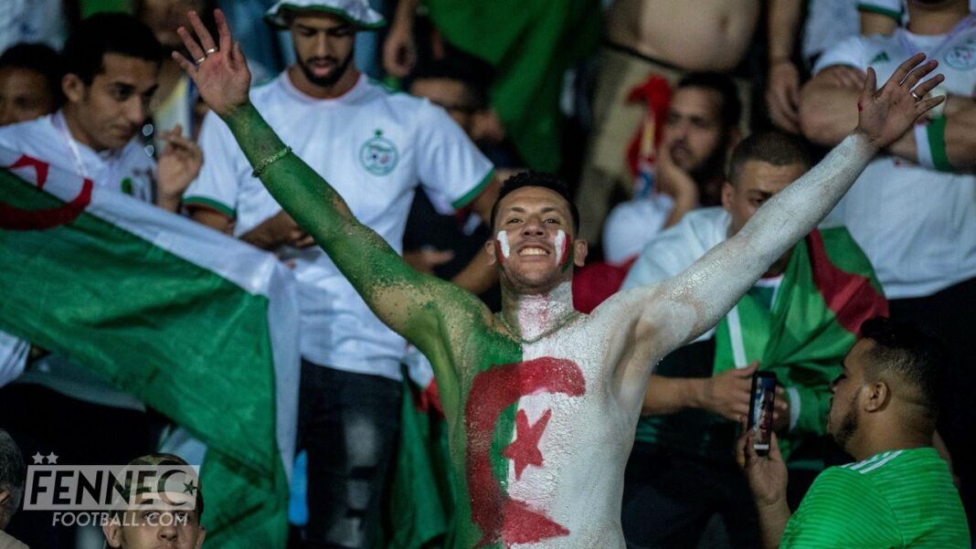 Eliminatoires CAN 2023 Algérie – Ouganda: Voici comment acheter vos tickets en ligne Supporter algérien avec drapeau et maquillage lors d'un match de football.