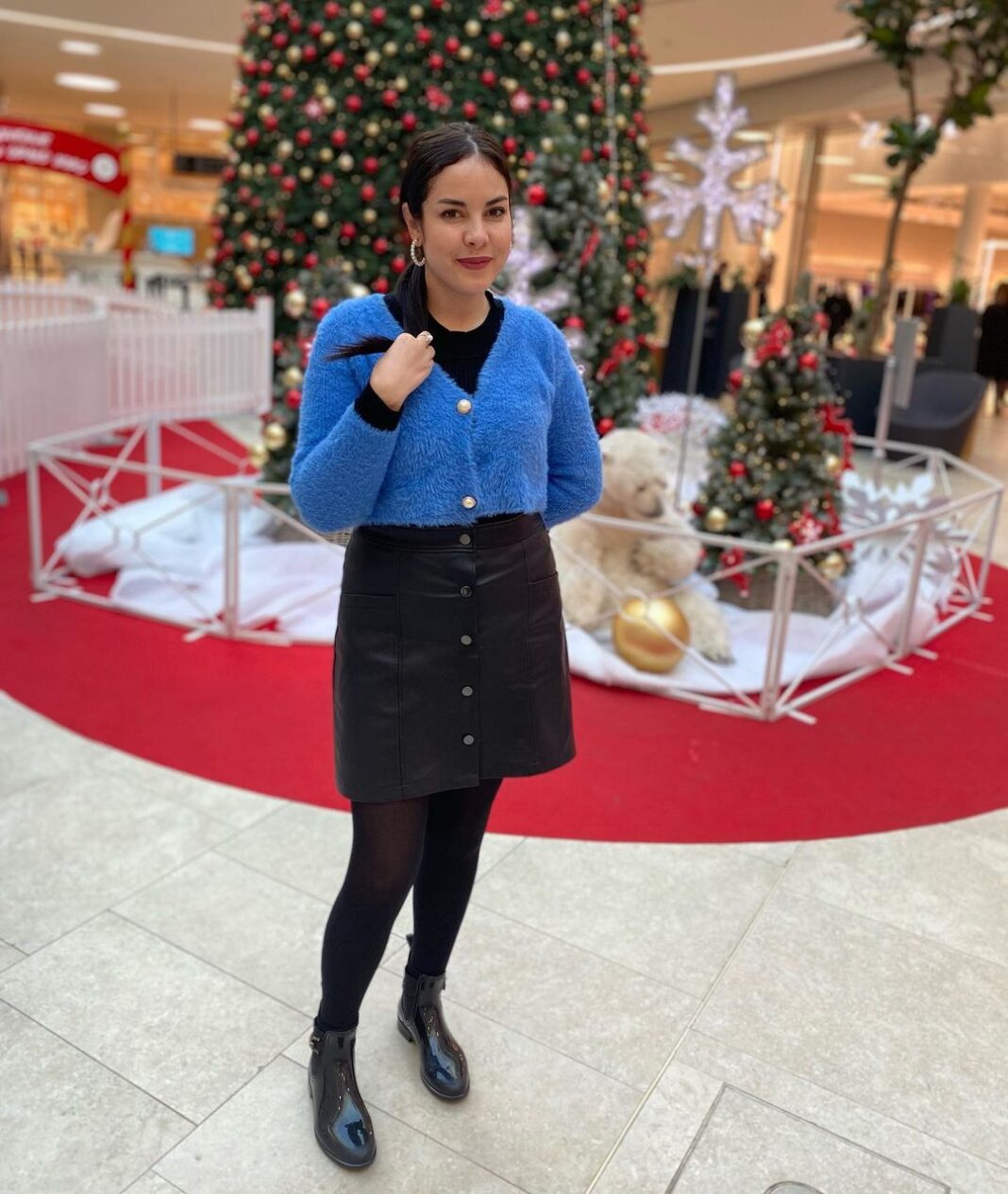 L’actrice Mouni Bouallam dégomme ses détracteurs Mouni Bouallam posant devant un sapin de Noël décoré.