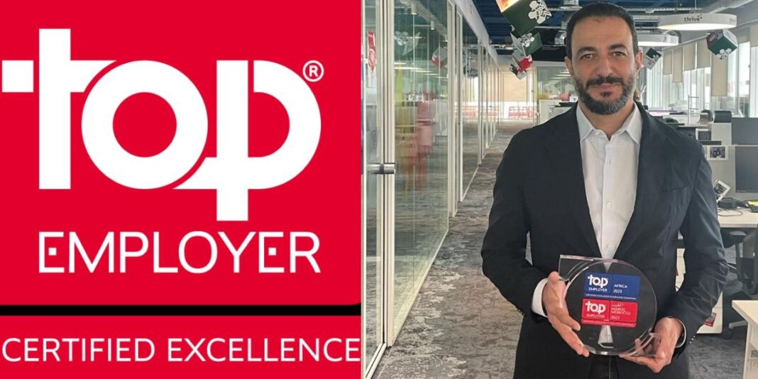 Top Employer Algérie 2023 Homme d'affaires tenant un prix Top Employer en Algérie.