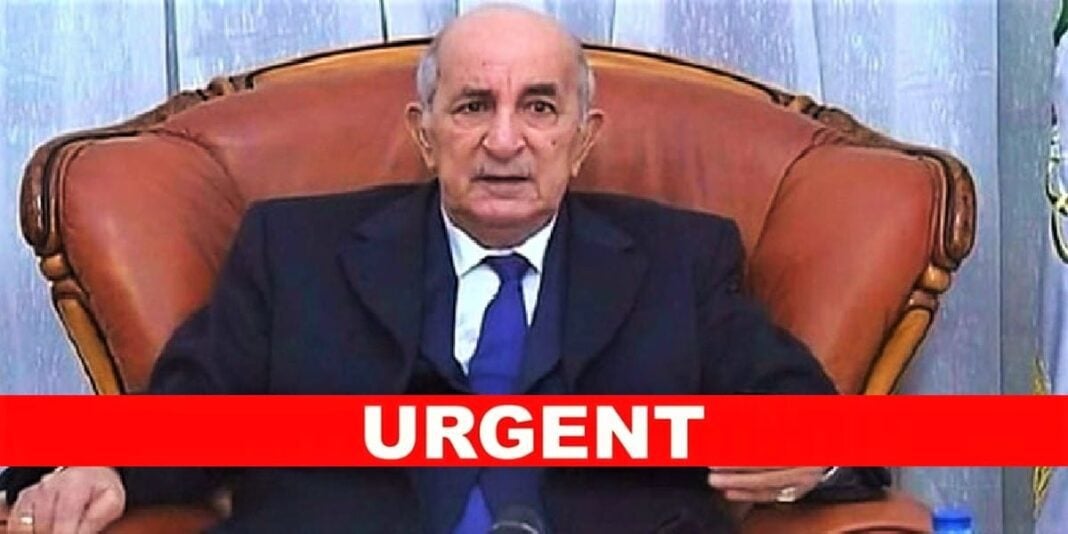 Tebboune en costume sombre, assis sur un fauteuil en cuir, parlant lors d'une réunion officielle.