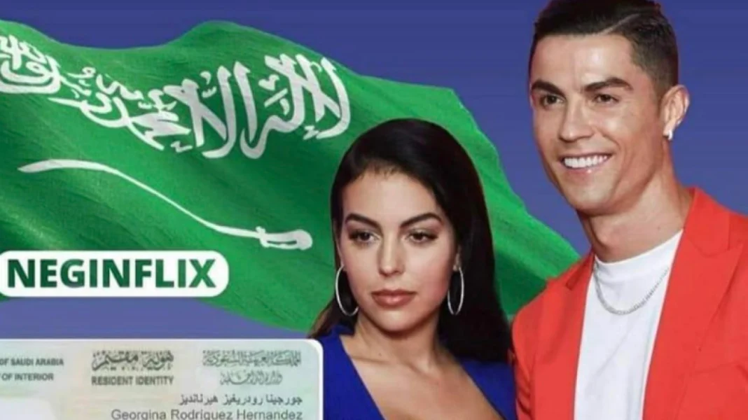La carte de séjour de Georgina en Arabie Saoudite…Une photo qui fait l’événement Georgina avec un drapeau saoudien en arrière-plan, sourire et style élégant.