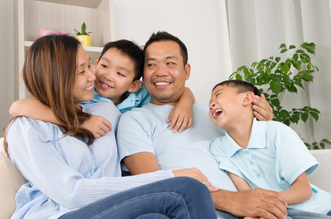 Famille souriante partageant un moment de bonheur à la maison.