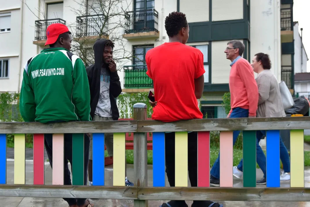 Enfin ! Les migrants en formation auront un titre de séjour sur la terre Espagnole Groupe de migrants discutant dans un parc en Espagne.