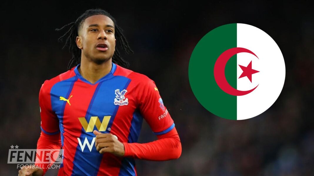 Michael Olise portant le maillot de Crystal Palace avec le drapeau algérien en arrière-plan.
