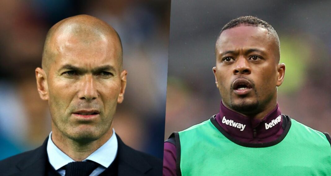 Evra et Zinedine Zidane en discussion Evra et Zinedine Zidane lors d'une rencontre sportive intense.