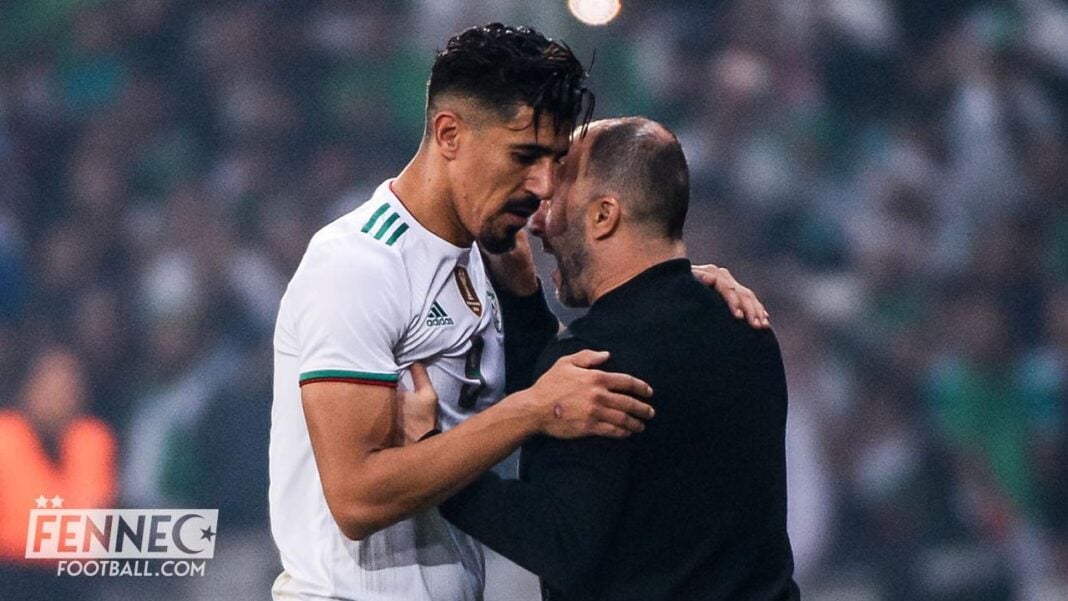 Équipe d’Algérie : Djamel Belmadi fixe des conditions strictes pour le retour de Baghdad Bounedjah Djamel Belmadi et Baghdad Bounedjah en discussion lors d'un match de football.