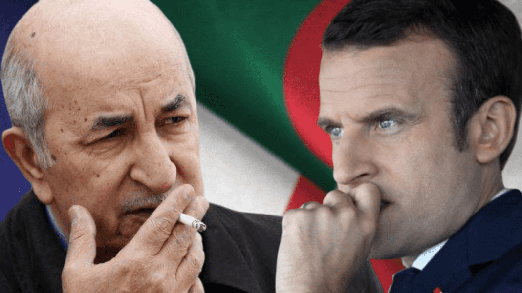 France : les Algériens traités de « radin », les sangs s’échauffent Deux hommes en conversation, l'un fumant une cigarette, avec un drapeau algérien en arrière-plan.