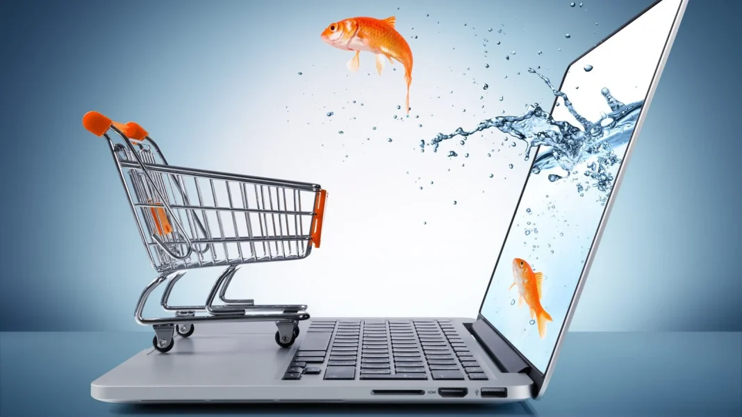 Poisson nageant dans un ordinateur portable avec un chariot de supermarché.