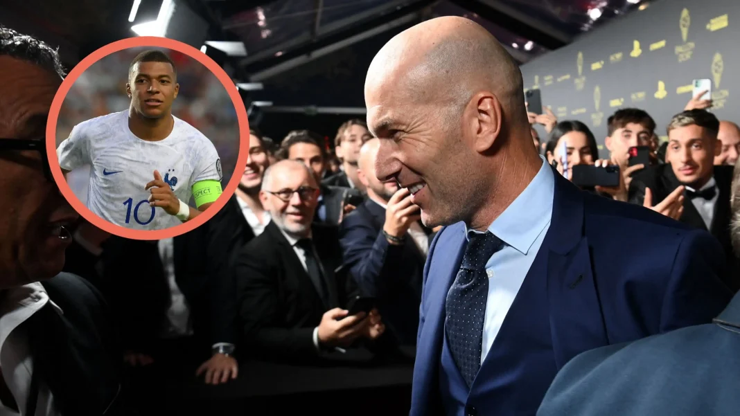 Zinédine Zidane fait une grande déclaration sur Kylian Mbappé Zinédine Zidane souriant lors d'un événement avec Kylian Mbappé en arrière-plan.