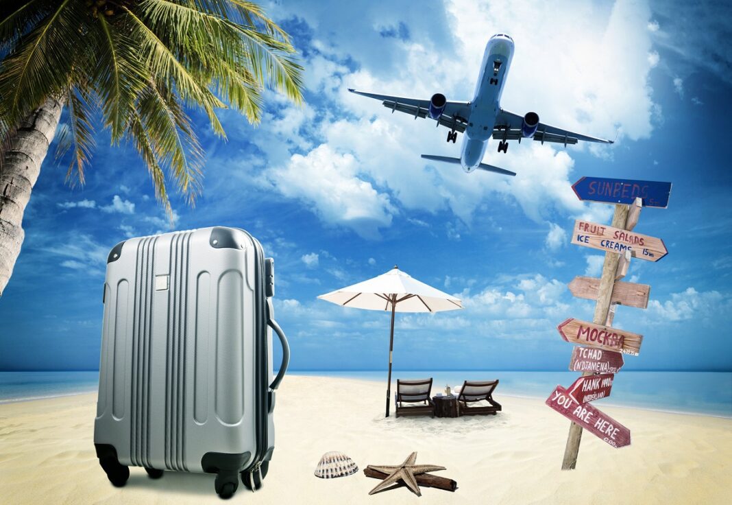 Vacances à la plage avec avion Avion survolant une plage avec valise, parasol et signaux de direction.