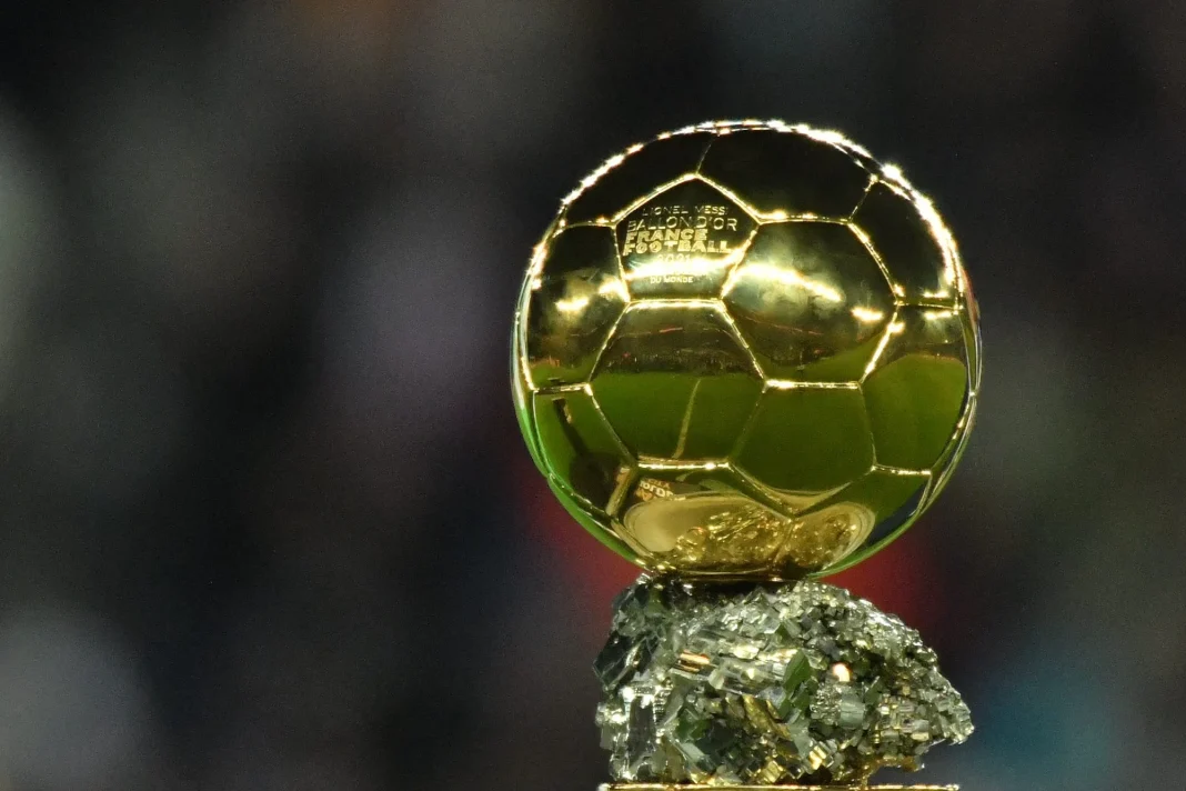 Ballon d'Or 2023 en or brillant sur un socle en pierre.