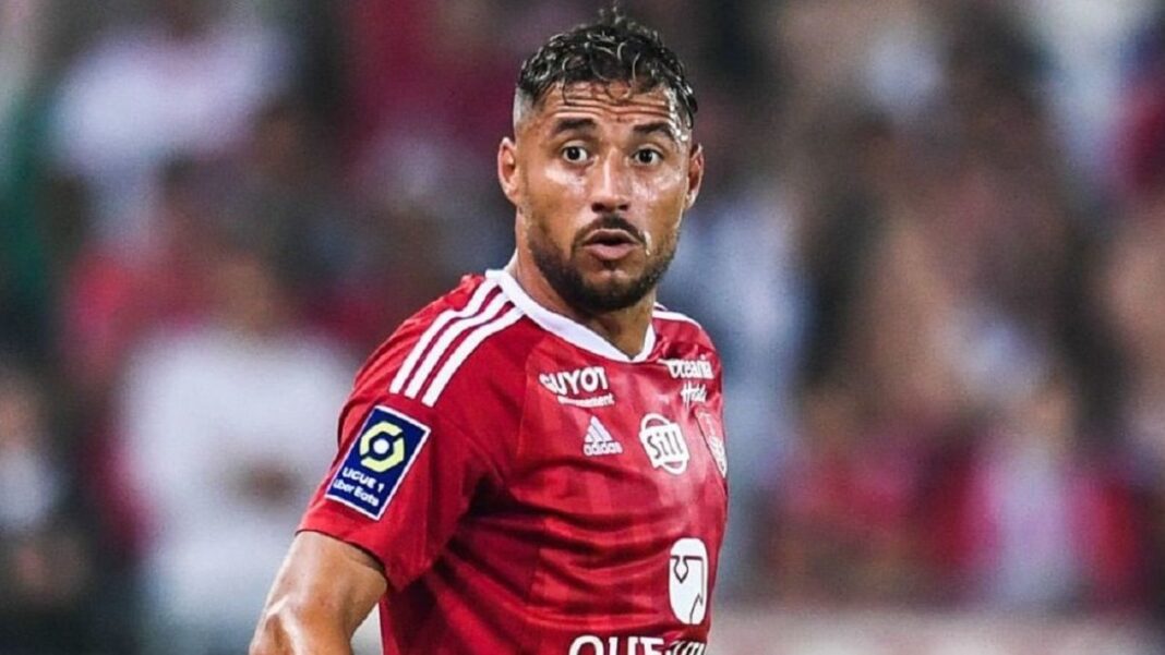 Youcef Belaili, joueur de football, en pleine action sur le terrain.