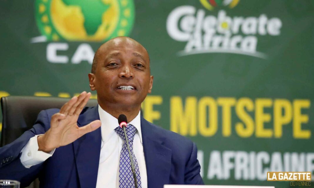 CAF-FAF : Patrice Motsepe jette des fleurs à l’Algérie Homme en costume lors d'une conférence de presse sportive.