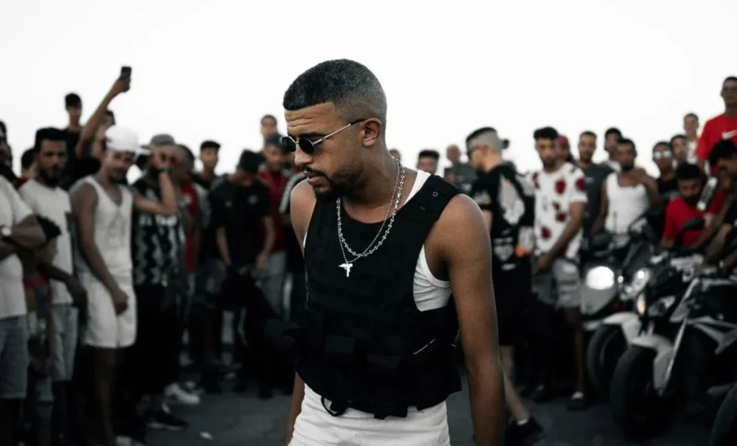 Hassen Junior, rappeur tunisien, entouré de fans lors d'un événement.