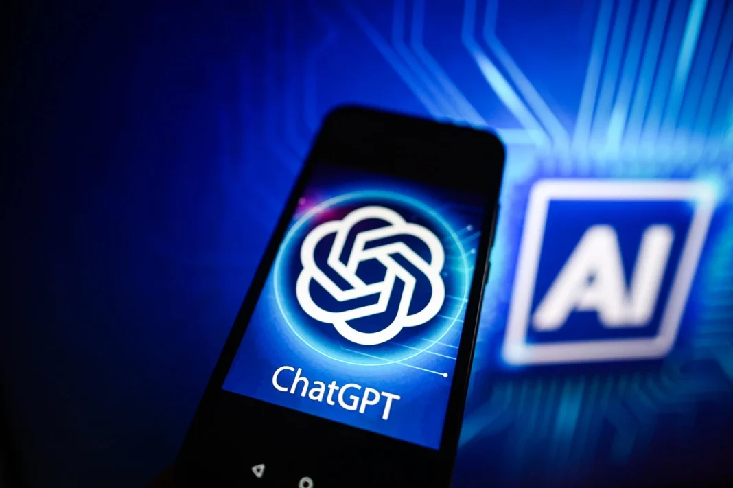 Impact de l’IA sur l’emploi : destruction ou création de postes ? Smartphone affichant le logo de ChatGPT et IA en arrière-plan.