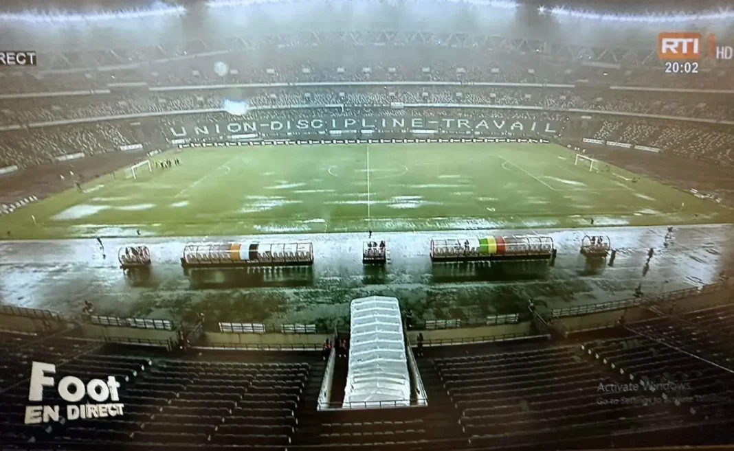 Stade de Côte d'Ivoire inondé avec des terrains submergés par la pluie.