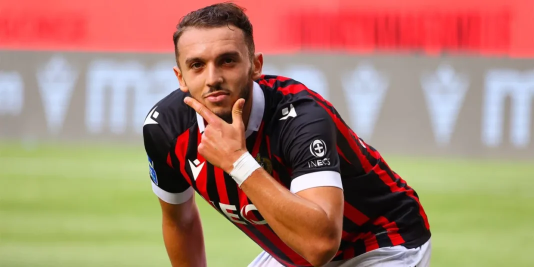 Amine Gouiri s’eclore : Plusieurs clubs européens en rude concurrence pour l’avoir ! Amine Gouiri, joueur de football, en pleine réflexion sur le terrain.