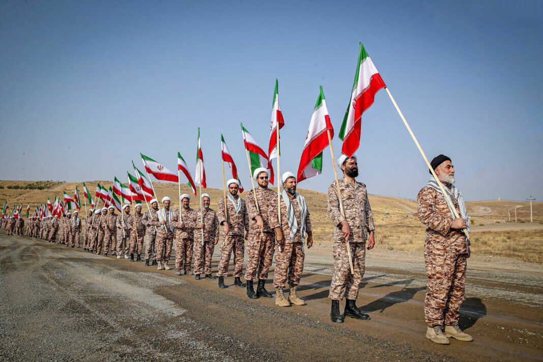 Soldats iraniens avec drapeaux Soldats iraniens en uniforme avec drapeaux lors d'une parade militaire.