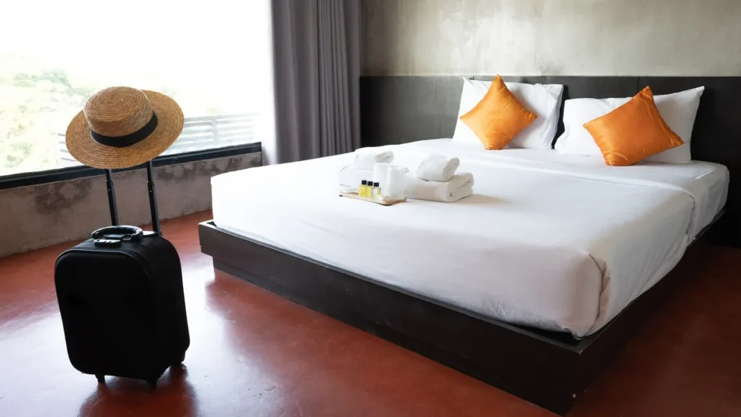Comment sécuriser sa chambre d’hôtel? Ces astuces simples vous sauveront la vie Chambre d'hôtel élégante avec lit double et vue sur l'extérieur.