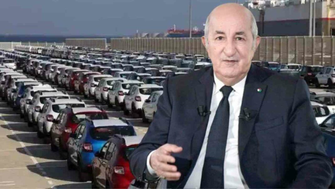 Lancement de Chery en Algérie Homme en costume devant un grand parking de voitures neuves.
