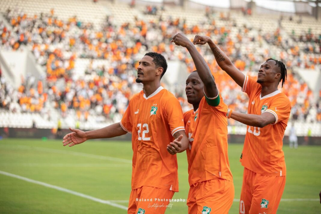 CAN 2023 : Le groupe A en ébullition – Prédictions et passions avant le coup d’envoi ! Joueurs de football en orange célébrant sur le terrain du CAN 2023.
