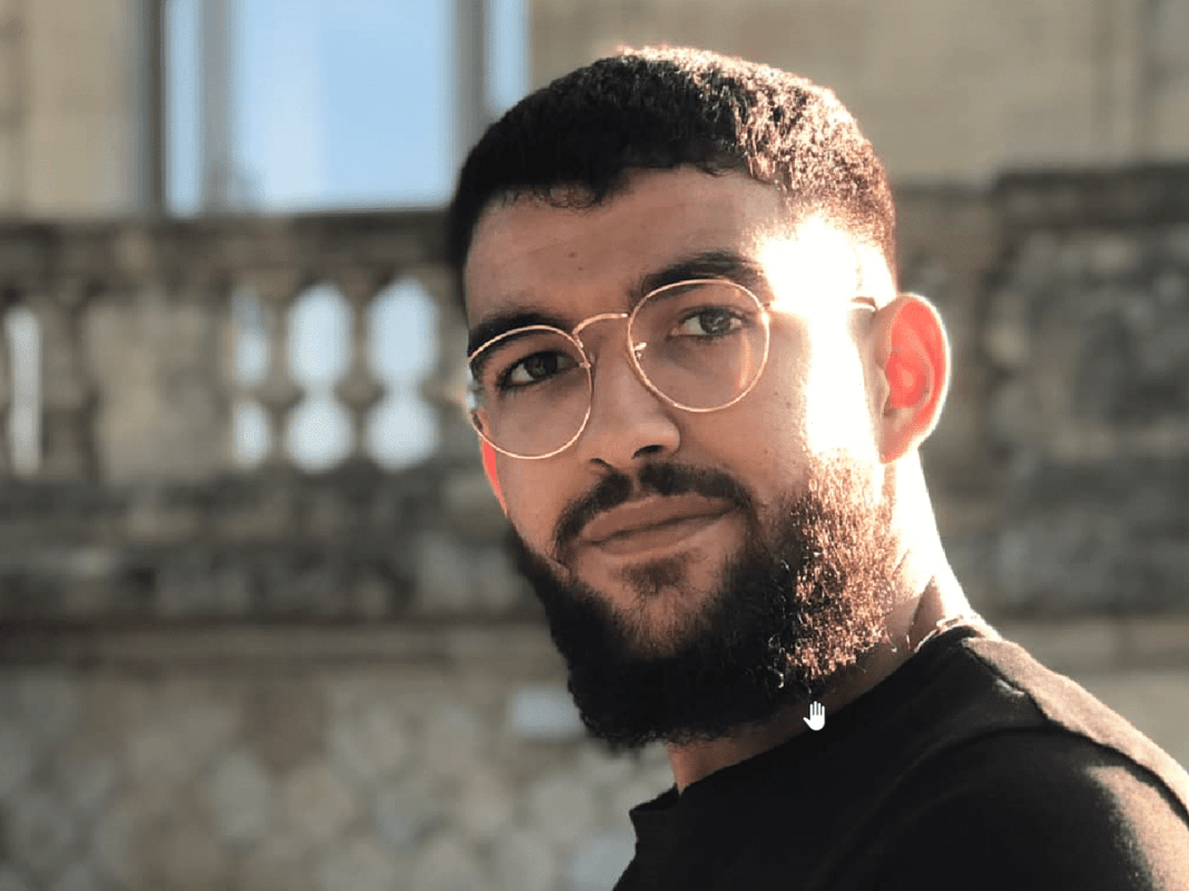 Rayane Lemmouchi : arrestation de 8 suspects dans l’affaire du jeune dentiste Algérien poignardé en France Portrait de Rayane Lemmouchi, jeune homme avec lunettes et barbe.