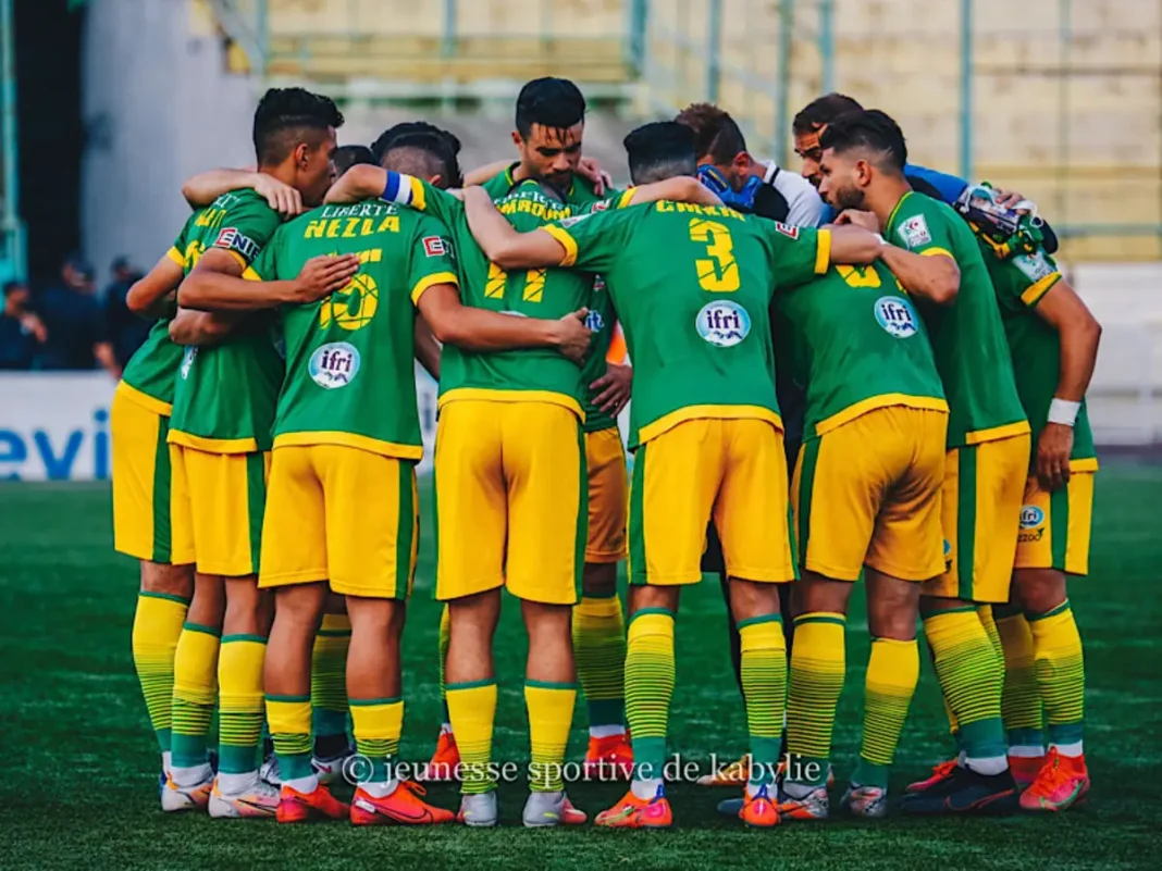 La JSk Kabylie, un pilier du football Mondial Groupe de joueurs de football en cercle sur le terrain.