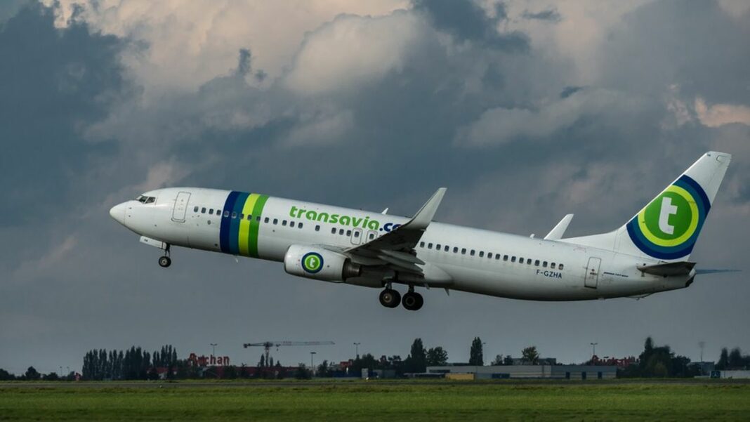 Transavia Airlines : vers une transition mémorable Avion Transavia en vol dans un ciel nuageux.