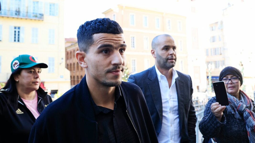 Youcef Atal condamné à 8 Mois de prison avec sursis : Un tournant sombre dans la carrière du défenseur de l’OGC Nice Youcef Atal entouré de personnes dans une rue urbaine.