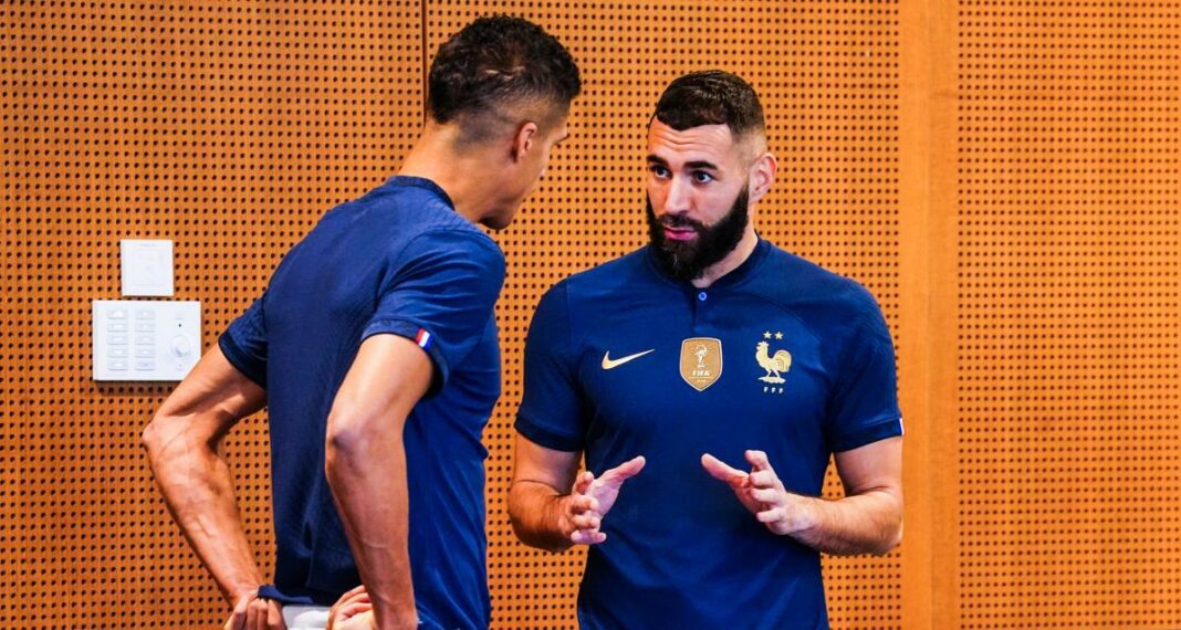 Karim Benzema en discussion avec un coéquipier Karim Benzema en conversation avec un coéquipier de l'équipe de France.