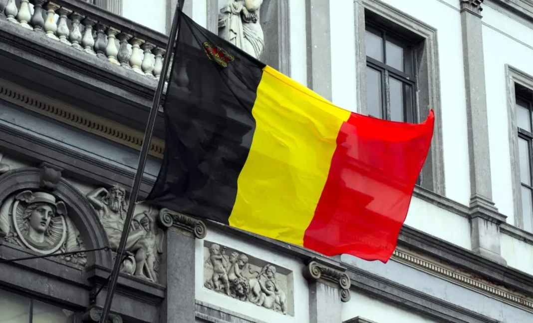 Drapeau belge flottant devant un bâtiment Drapeau belge en tissu flottant devant un bâtiment historique.
