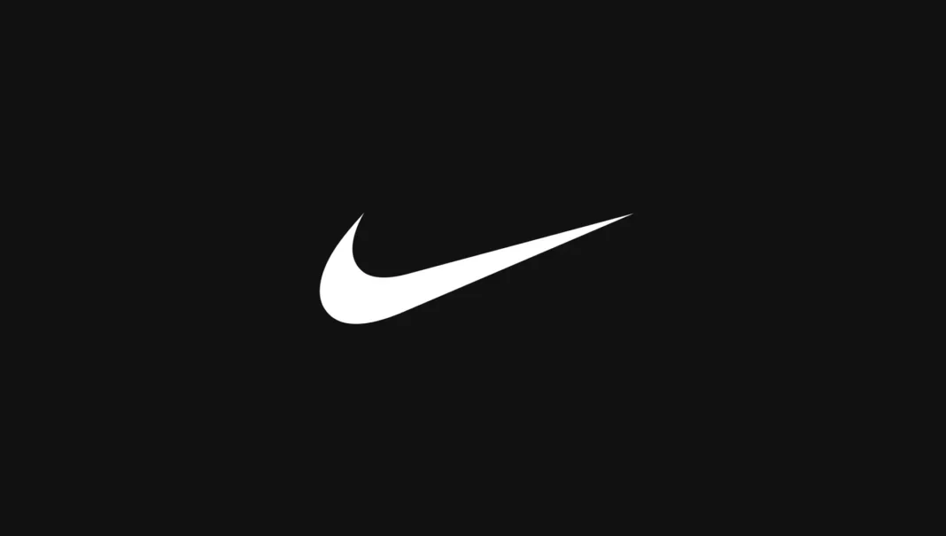 JO de Paris 2024 : Nike surprend l’Algérie avec des équipements au design audacieux Logo Nike blanc sur fond noir, symbole de sport et de performance.