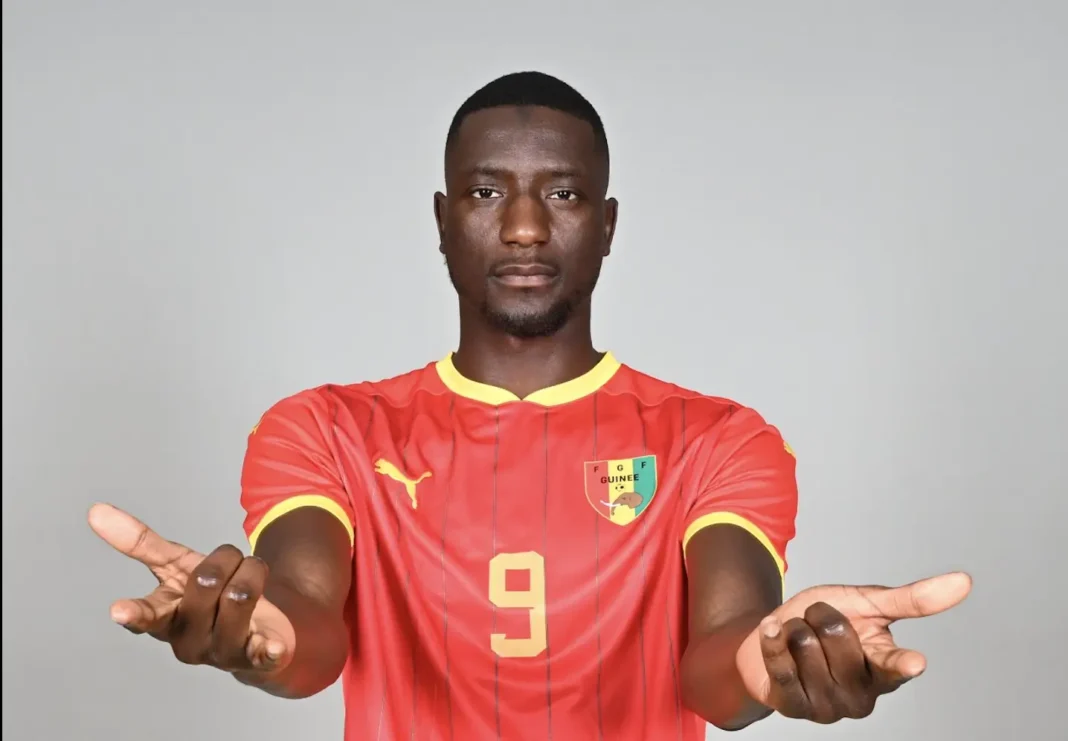 Algérie – Guinée : Serhou Guirassy révèle sa stratégie secrète pour terrasser les Fennecs ! Footballeur en maillot rouge, prêt à jouer pour l'équipe nationale.
