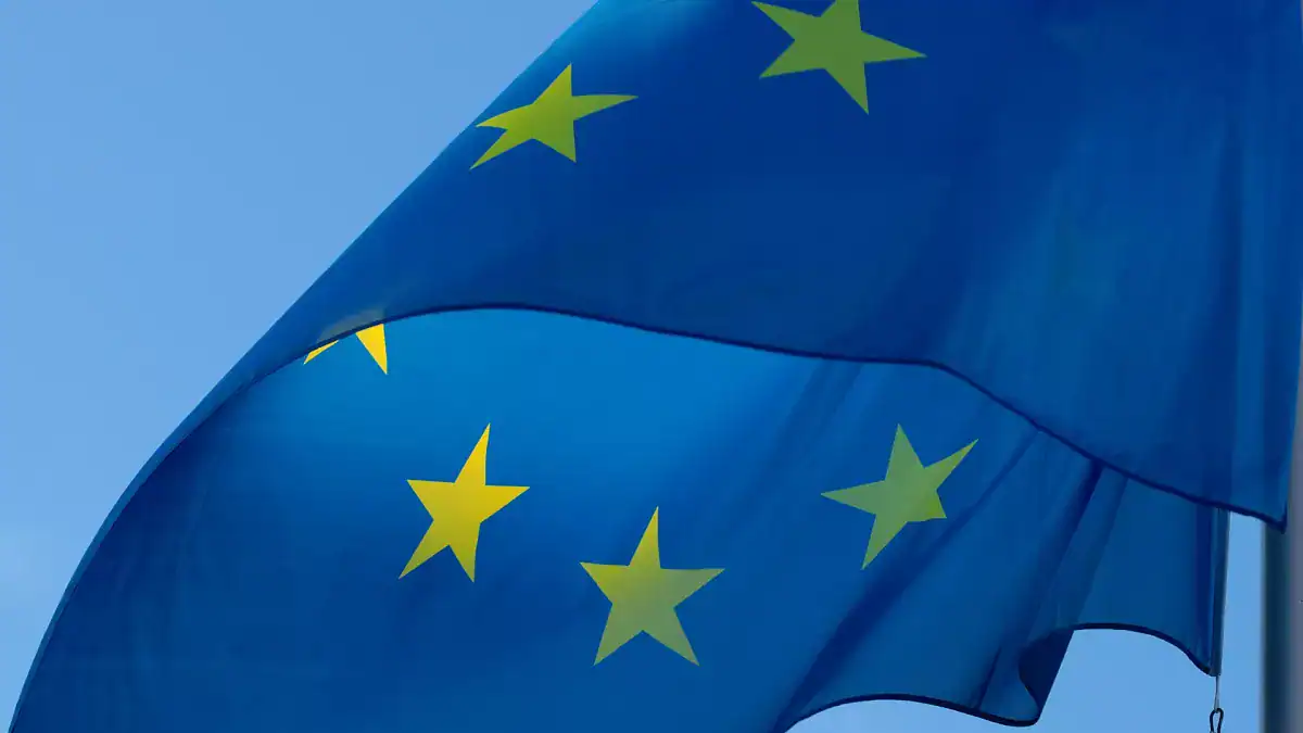 Drapeau de l'Union Européenne flottant dans le ciel bleu.