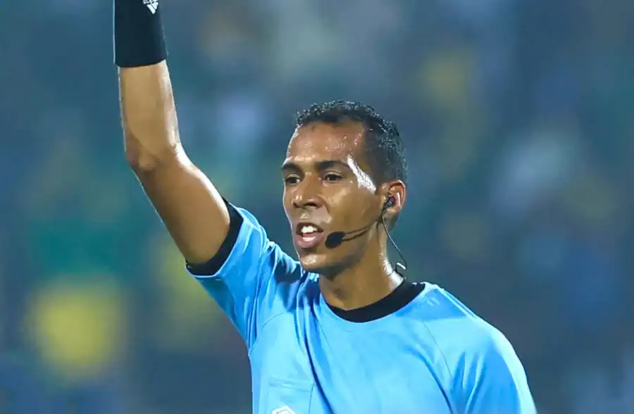 Arbitre de football en train de prendre une décision sur le terrain.