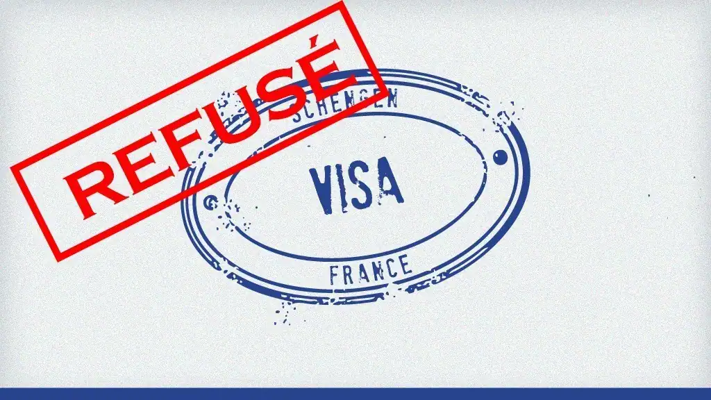 Visa refusé avec stamp rouge 'REFUSÉ' sur document officiel.