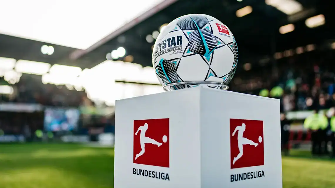 l’Algérie rayonne en Europe : Gouiri et Amoura brillent Ballon de football de la Bundesliga sur un socle au stade.