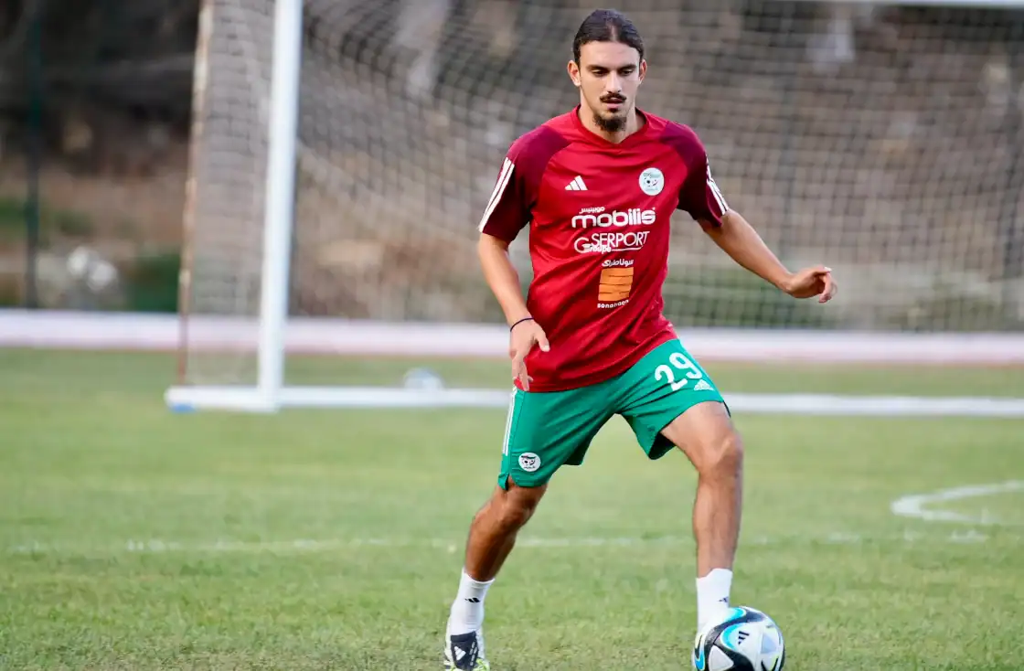 Un nouveau talent Franco-Algérien opte pour les Verts Jeune joueur de football franco-algérien en entraînement sur le terrain.