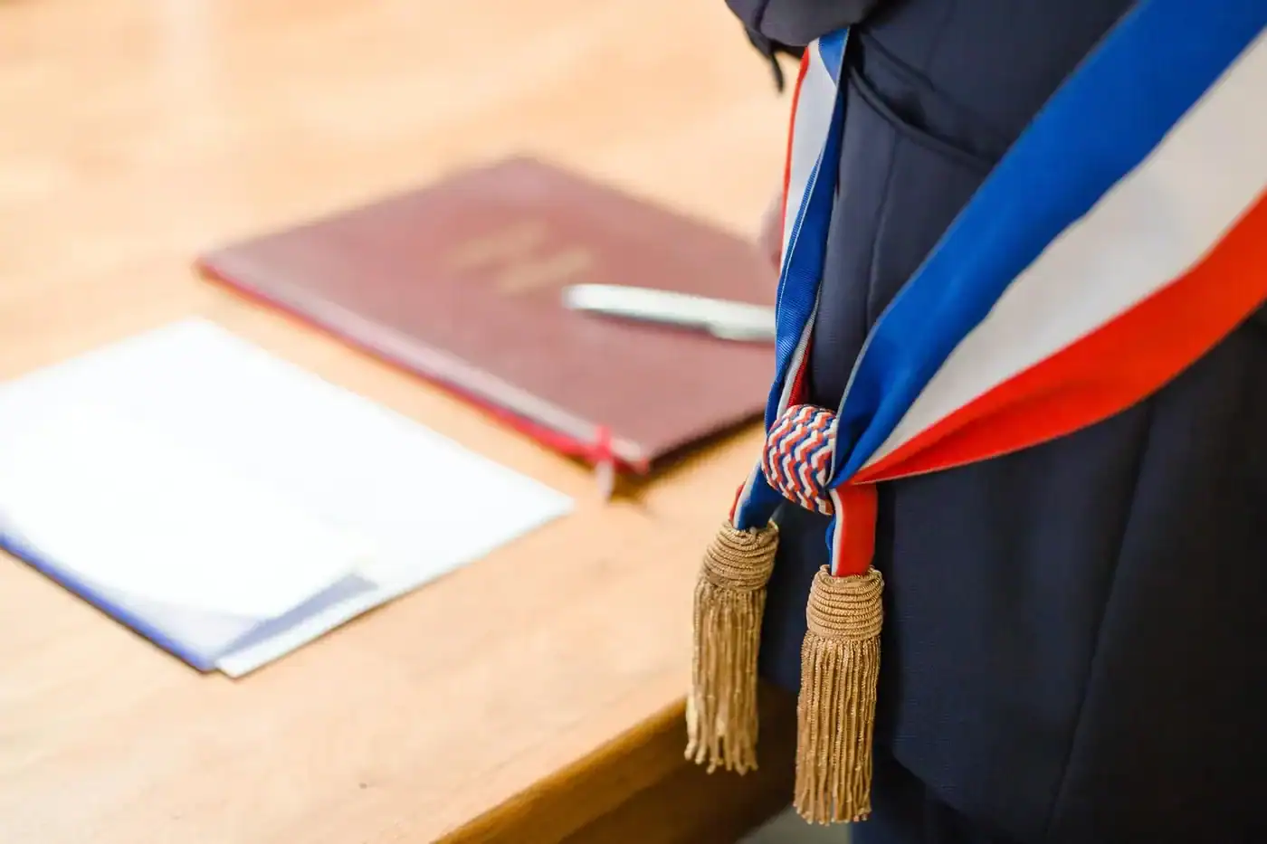 Mariage de sans-papiers : ce qu'en pensent les Français Étudiant en robe de graduation avec écharpe tricolore.