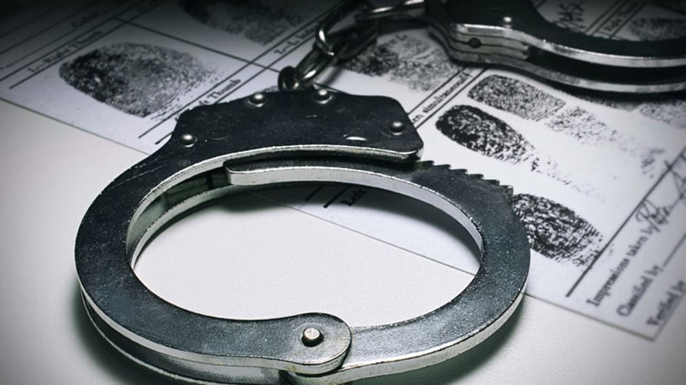 Menottes et empreintes digitales pour enquête criminelle.