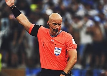 Arbitre Marciniak en action lors d'un match de football international.